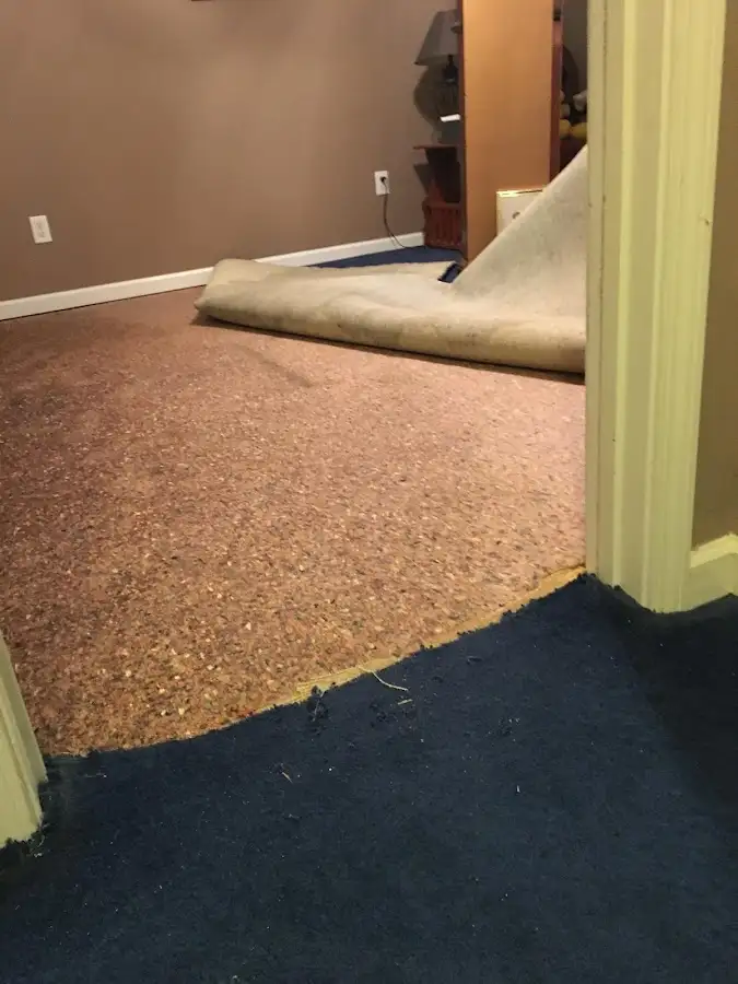 Carpet pad removal revealing water damage during Water Mitigation Services in Modesto